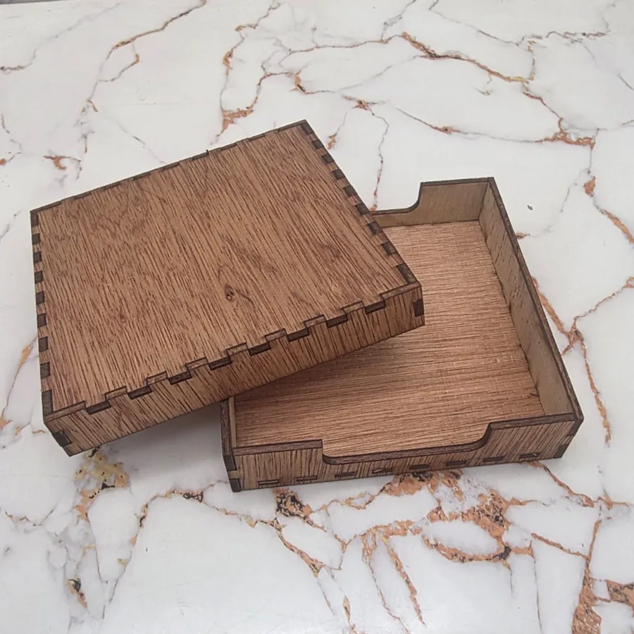 Finger-jointed wooden coaster box with the lid lifted off, showing the tray and its thumb notch